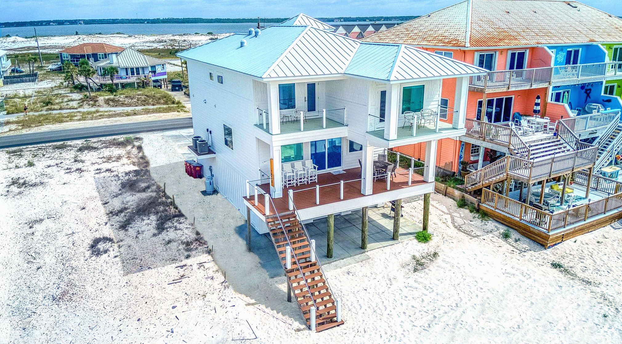Modern coastal piling home on Navarre Beach by Acorn Fine Homes