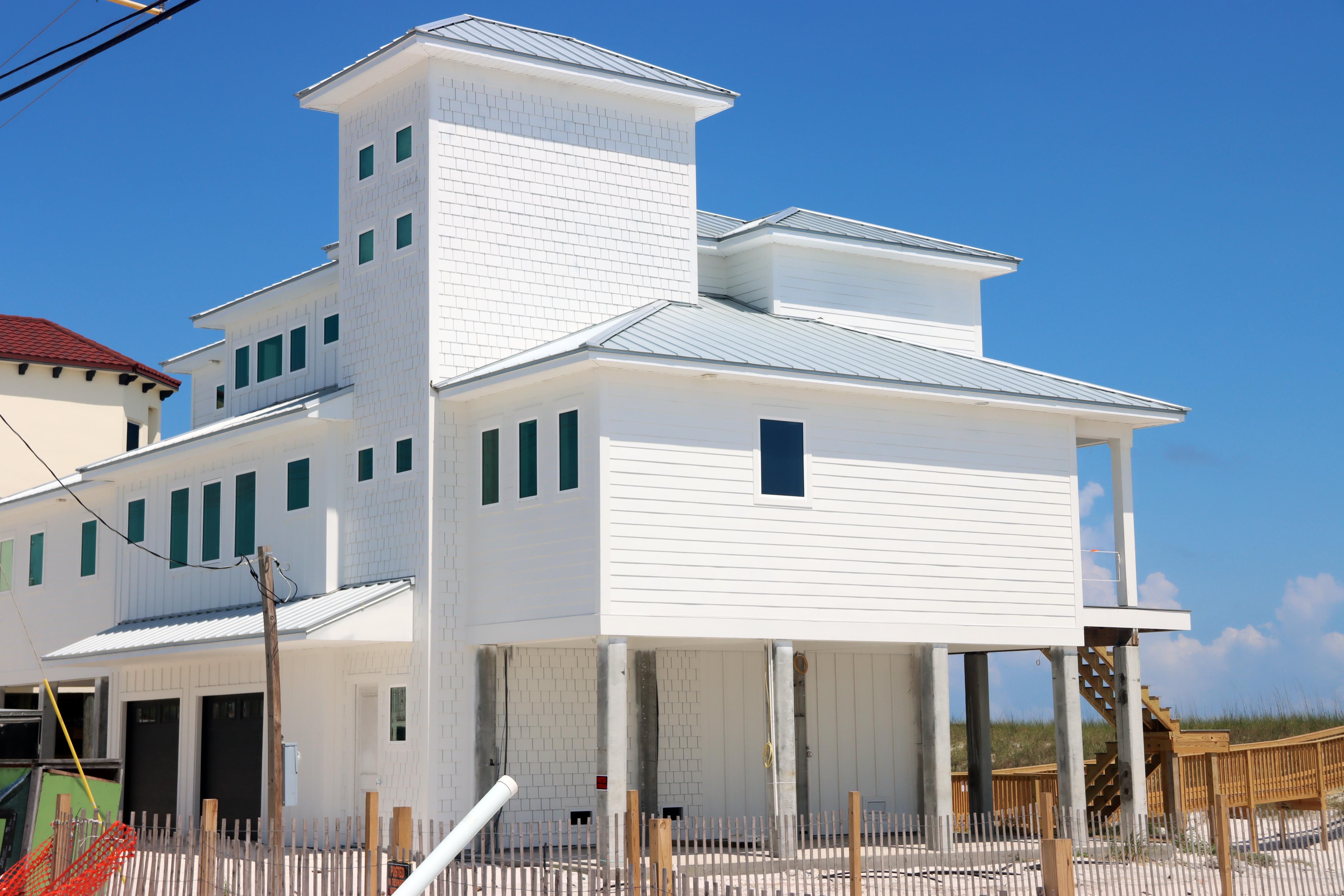 Davis modern coastal piling home on Navarre Beach by Acorn Fine Homes