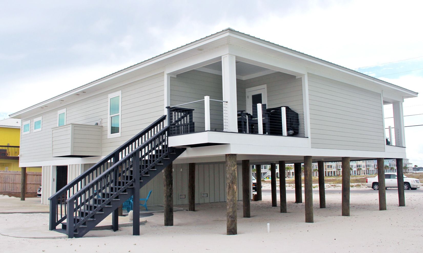 Moreland modern piling home on Navarre Beach by Acorn Fine Homes