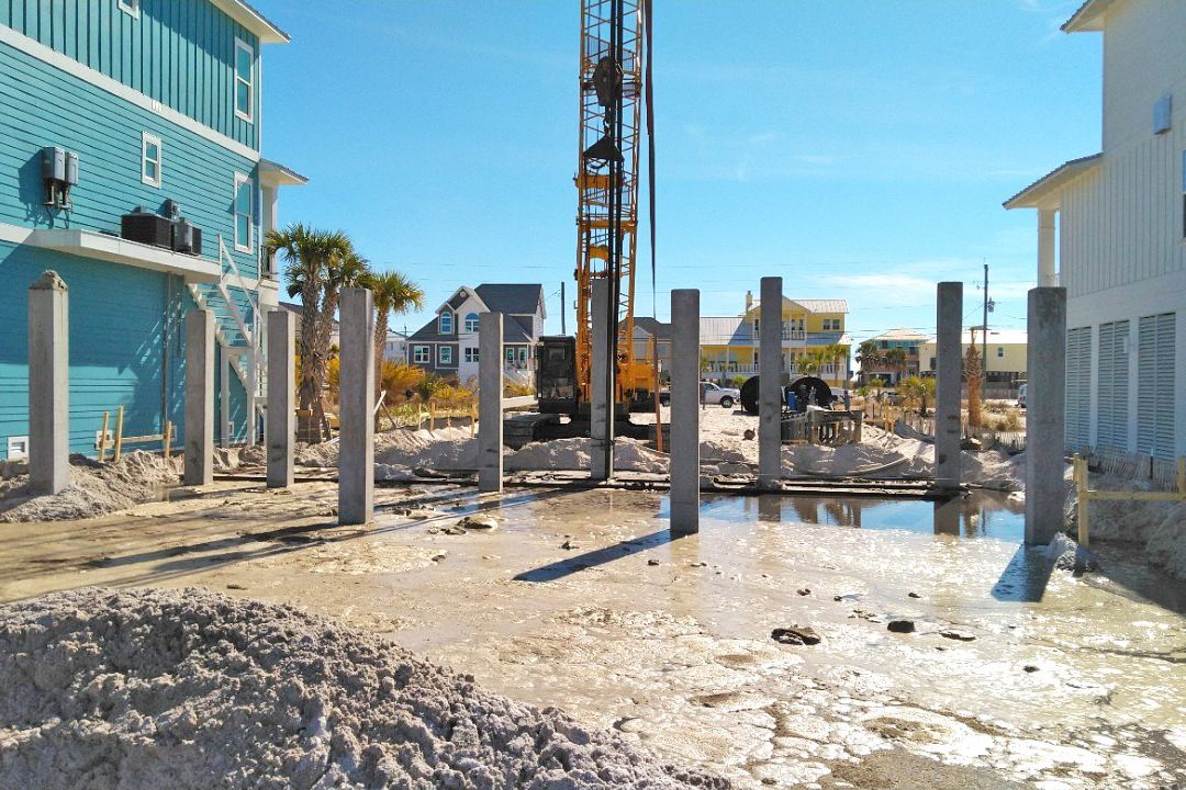 Modern coastal piling home on Navarre Beach by Acorn Fine Homes