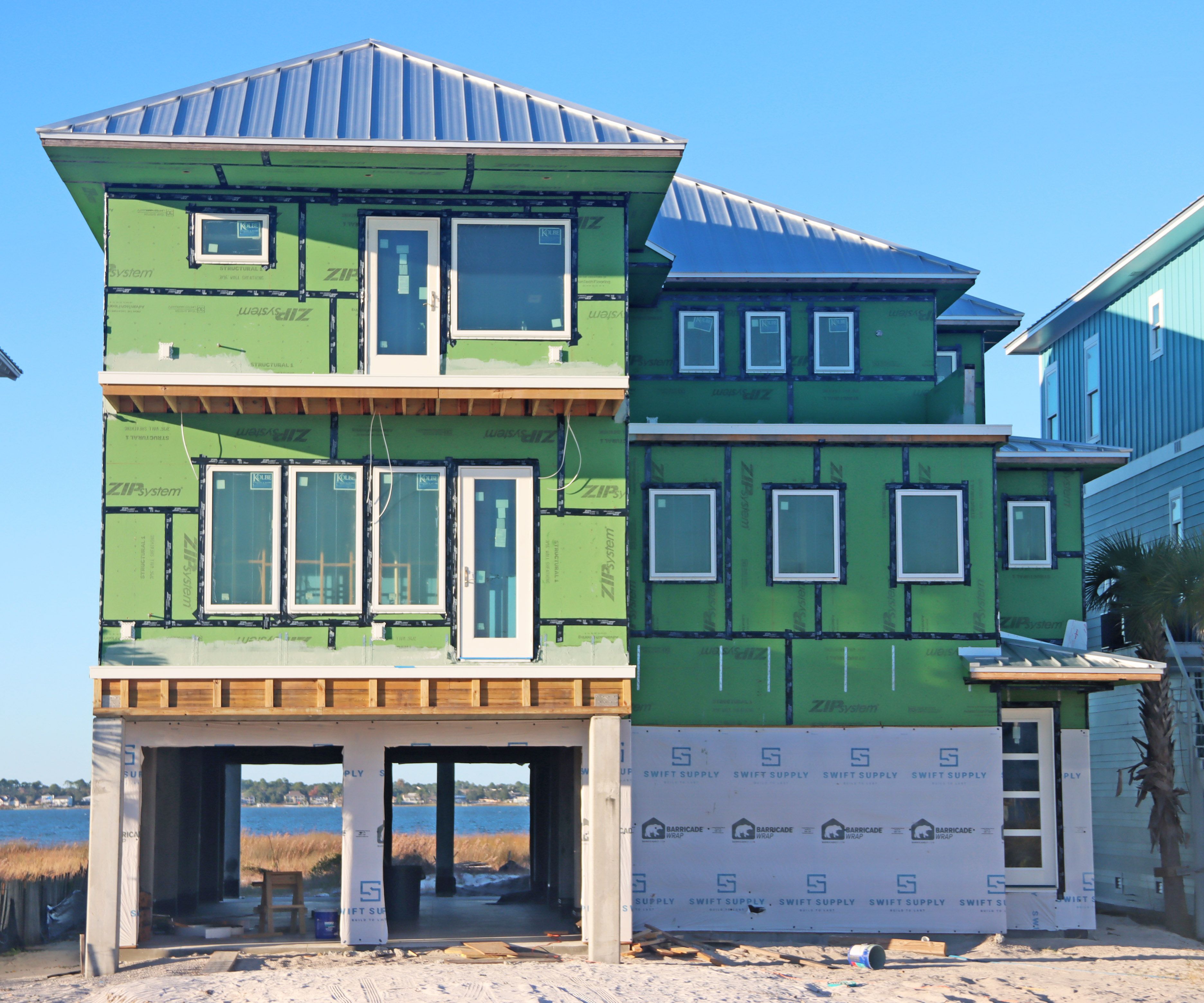 Modern coastal piling home in Navarre by Acorn Fine Homes