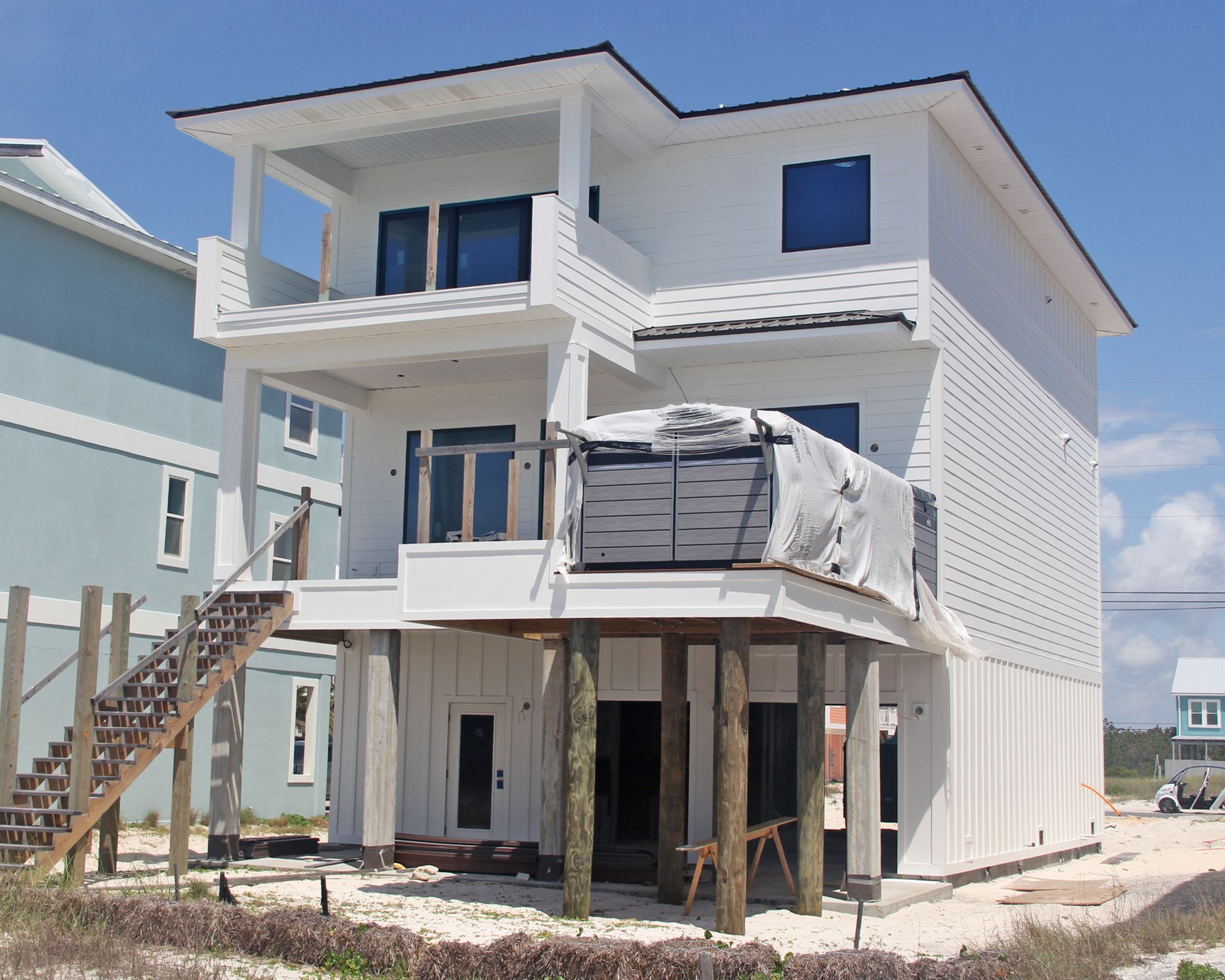 Davis modern coastal piling home on Navarre Beach by Acorn Fine Homes