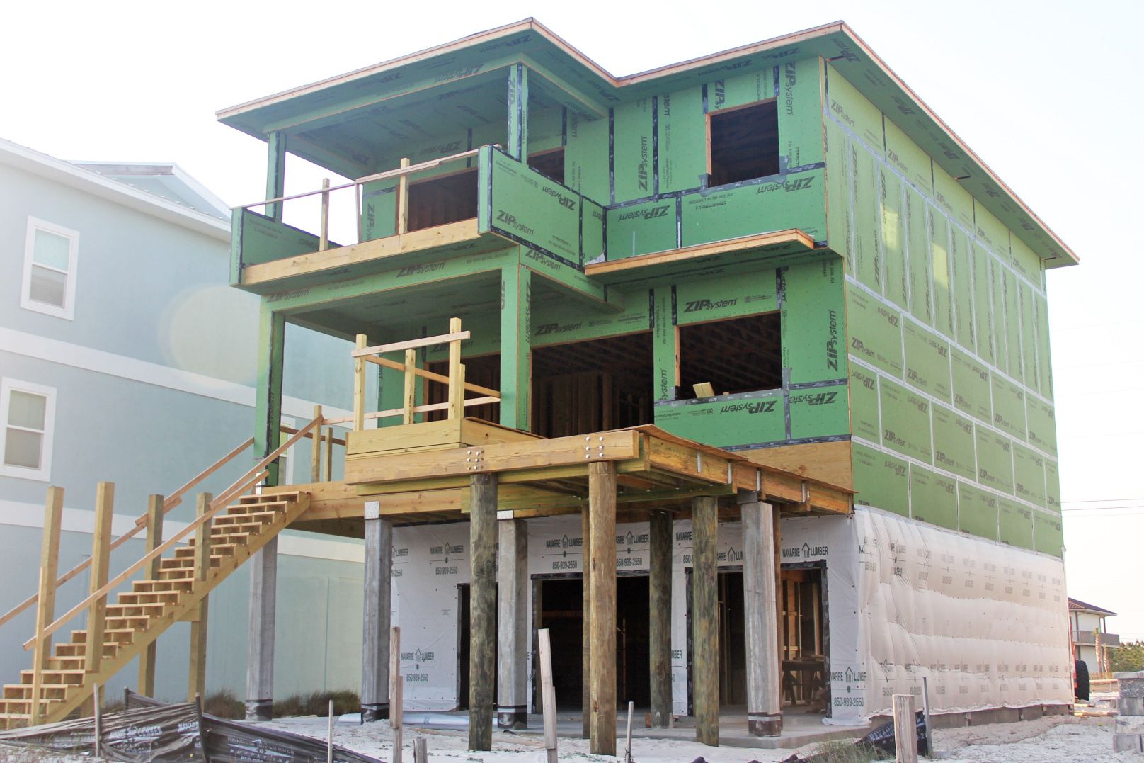 Davis modern coastal piling home on Navarre Beach by Acorn Fine Homes